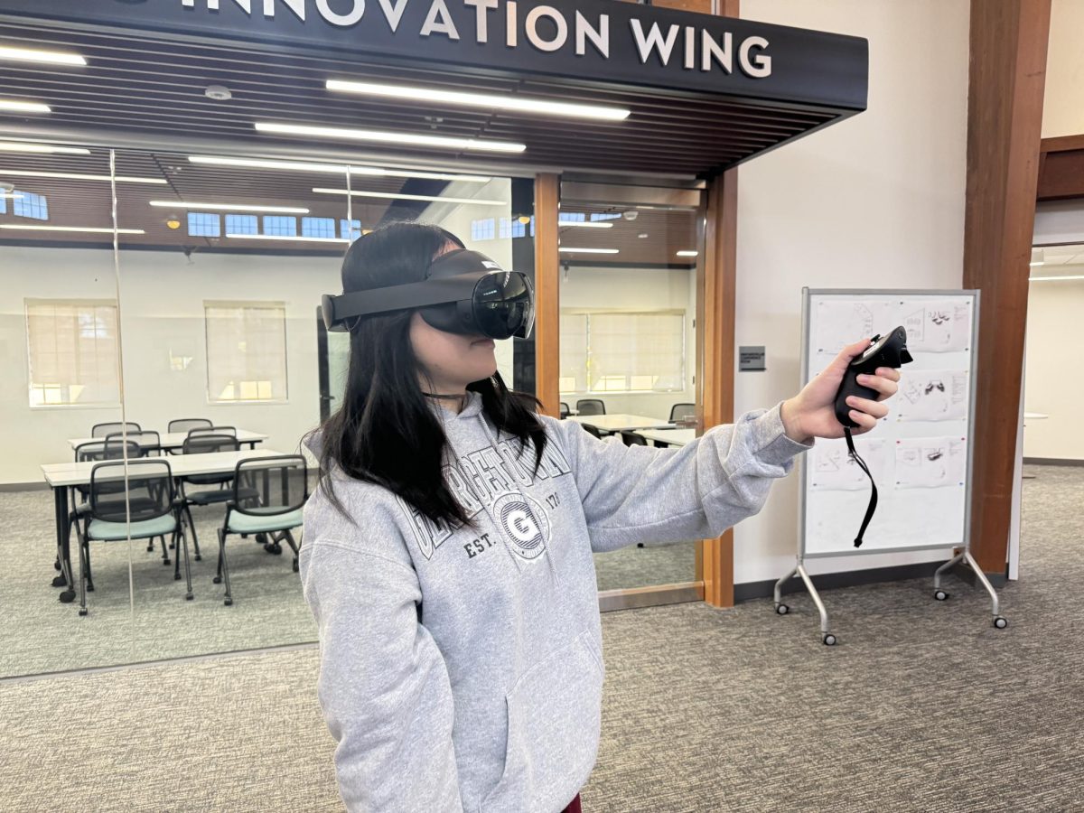 Kathy Duan (’25) is wearing the VR goggles to explore structure of the human body in front of the Charles Huang Innovation Wing. Science classes at Webb have started incorporating VR into their curriculums. “It’s a brand-new experience to use these VR goggles,” said Eric Zhu (’25), an Advanced Studies Anatomy & Physiology student. This approach allows students to explore anatomy through hands-on, immersive technology. 