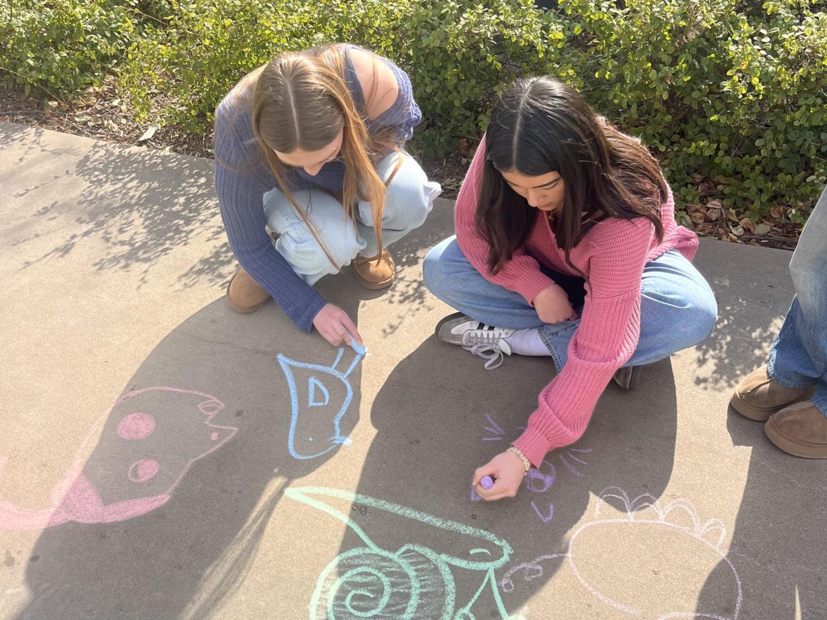 Frannie Hinch (‘25) and Yuki Layman (‘25) brighten the quad through decorative chalk art. This is one of the many activities the peer advisors put on to celebrate Stress Less Week. “It was a really fun way to de-stress because drawing particularly with chalk is a really calm thing for the mind,” Yuki said. The colorful designs brought a cheerful touch to campus, lifting everyone's spirits.