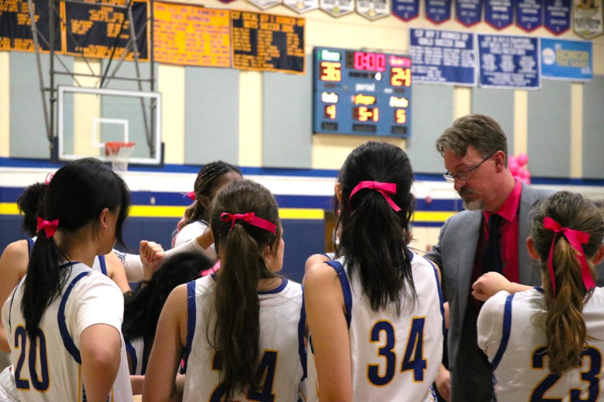 The girls' basketball team rallied in pink ribbons, ready to gather their support for cancer survivors while playing a nail-biting game. Bolstered by their competitive spirit, the team joined with the American Cancer Society and the National Association of Basketball Coaches in an event called Coaches vs. Cancer. “By being here, you are showing that your community stands united,” said Coach Kays, science department faculty and Webb’s girls’ basketball head coach “You're demonstrating that in the face of cancer, we refuse to be silent.” The game included packed stands with fans supporting the team, and the cause! 