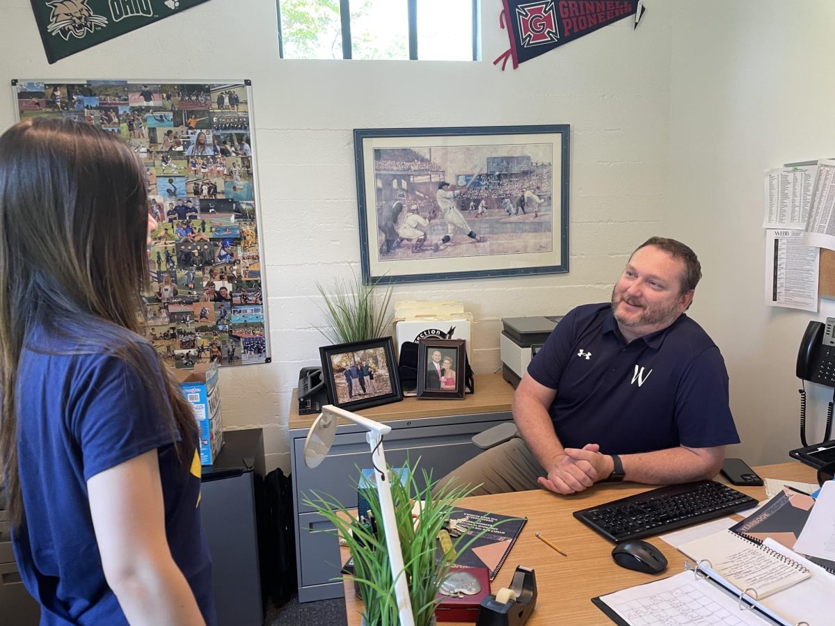 Steve Wishek, Director of Athletics and Afternoon Activities, speaks with Qianqian Jia (‘25) about a basketball game. For years, students have come to this door to change their afternoon activities, obtain exemptions, or simply chat. “Mr. Wishek really understands the student experience and what particular problems we might be going through,” said Tony Gao (‘26), Mr. Wishek’s advisee. But as he prepares to depart next year, let’s reflect on the legacy Mr. Wishek has left during his 22 years at Webb.